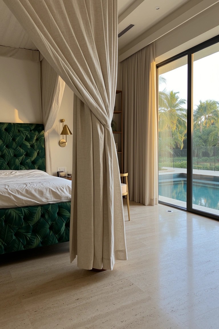 Tropical bedroom with green palm-patterned canopy bed, sheer drapes, and sliding doors to outdoor pool area