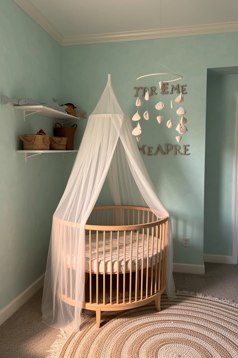 Nursery with mint green walls, round wooden crib under white sheer canopy, shell mobile hanging above, and woven rug on floor