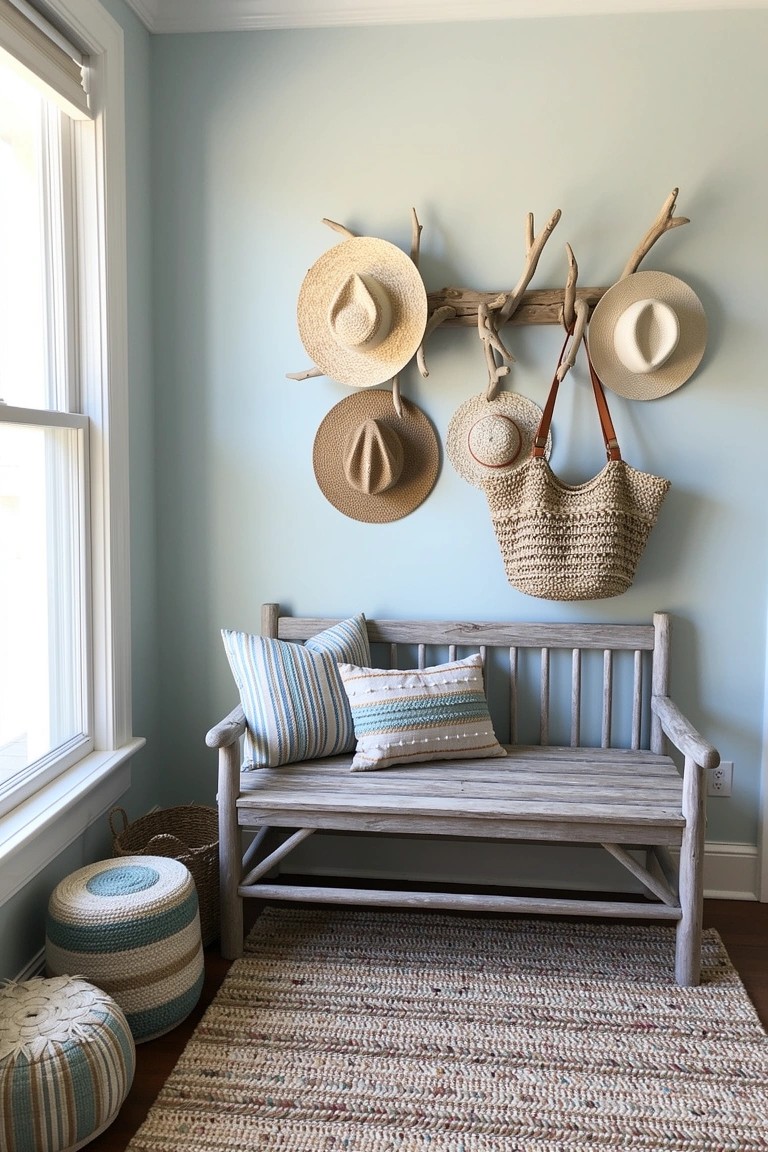 Antler branches mounted on light blue wall holding straw hats and a woven bag above a cushioned wooden bench