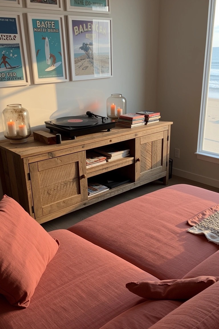Rustic wooden console with turntable, candles, books, and jars, surf posters on wall by ocean window