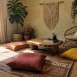 Cozy bohemian room with macrame wall art, rustic table, and earth-toned floor cushions.
