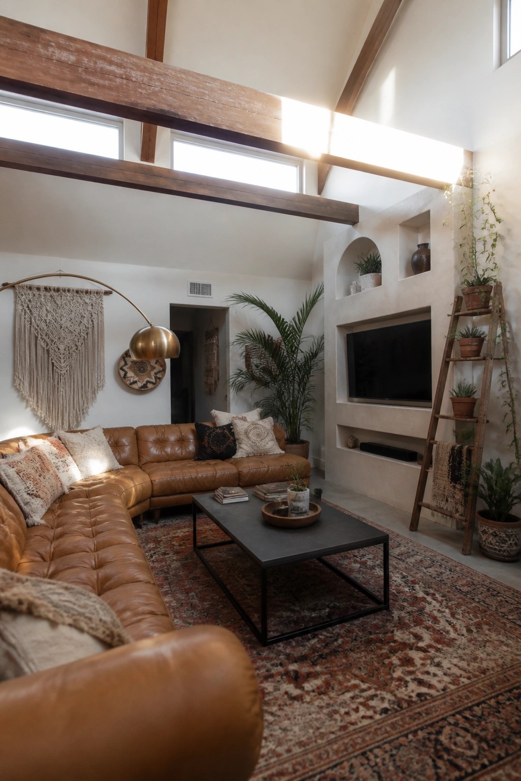 Modern boho living room with leather sectional, black coffee table, and wooden plant ladder